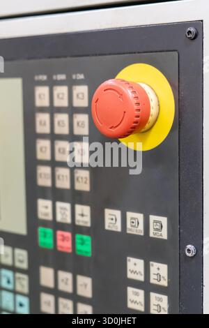 Red emergency stop button on an industrial control panel Stock Photo