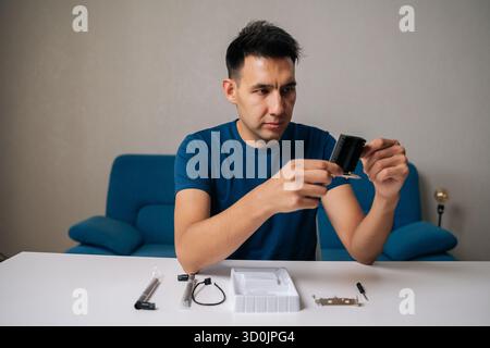 Portrait of skilled computer technician preparing to installing wi-fi module onto computer motherboard, enhancing hardware for better wireless Stock Photo