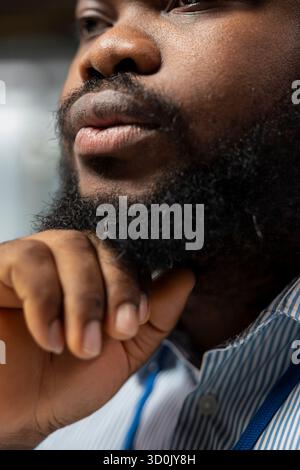 Close up of equity analyst in office doing audit of company earnings reports to forecast stock performance. African american man monitoring industry trends and company news for investment insights Stock Photo