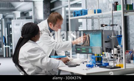 Diverse team of scientists collaborating in a modern laboratory, conducting experiments with laboratory equipment. Research study for biotechnology, genetics and molecular biology. Stock Photo