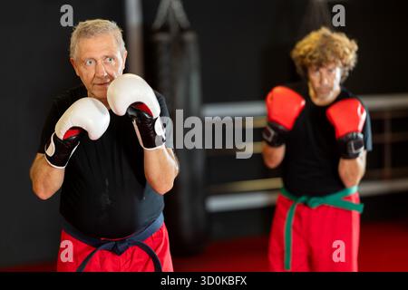 Senior man preparing for sparring in boxing gloves Stock Photo