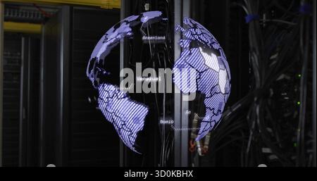 Projecting holographic globe floating in server room, with server cabinets and network cables Stock Photo