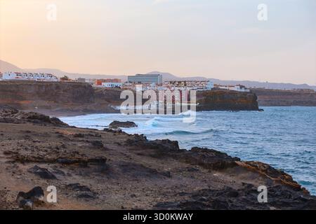 Cluster of buildings and hotels sits atop cliffs, which is area around Bufadero de la Garita and Playa del Hombre in Gran Canaria. Rocky coastline Stock Photo