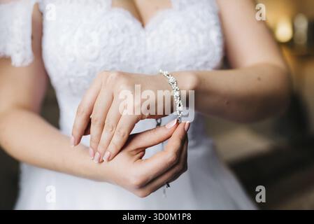 The bride wears a wedding bracelet on her left hand Stock Photo