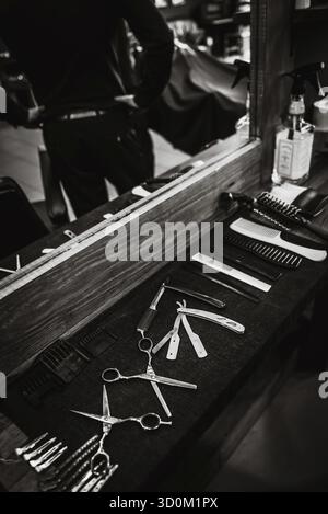 The tools of a Barber on the desktop in front of the mirror Stock Photo