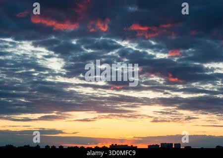 Awesome sunset and dark clouds with pink tones. Image template of textured sky. Gorgeous photo wallpaper. Bright epic sky. Dramatic evening light and Stock Photo