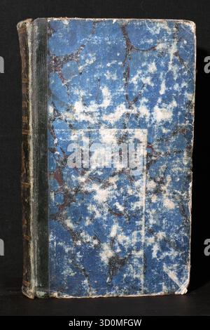 A closed antique book with a heavily worn blue, white, and burgundy marbled paper cover and a deteriorated dark leather spine (front and back view). Stock Photo