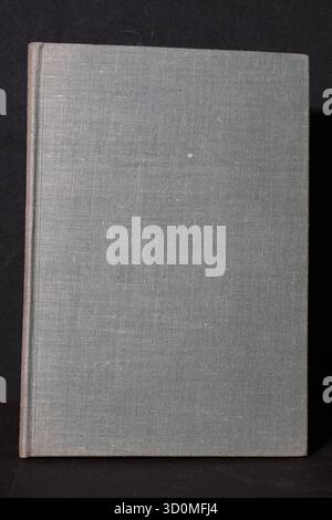 Hardcover books bound in contrasting two-tone cloth (navy blue/light blue) or plain grey-blue cloth. Focus is on the fabric texture and sim Stock Photo