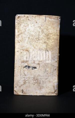 Unadorned, textured cover of very old book, likely bound in rough parchment or light-colored, pebbled leather. Feavy wear, stains, and aging Stock Photo