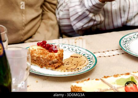 Layered ice cream cake decorated with fresh strawberries and raspberries, served on a table during a festive occasion. Stock Photo