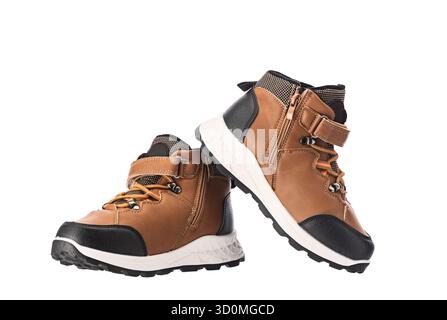 Kids Shoes Brown Hiking Boots With Black Toe Cap And White Sole For Outdoor Adventure Durable Trail Footwear for Autumn and Winter season isolated on Stock Photo