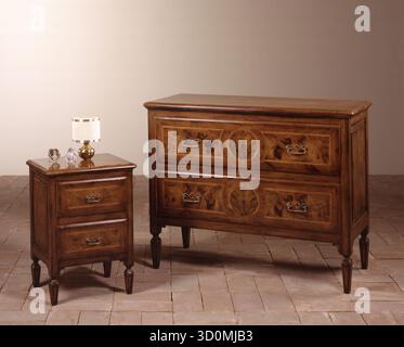 Still life of a classic-style wooden chest of drawers and bedside table Stock Photo