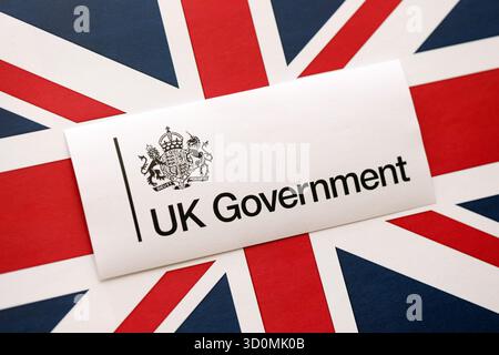 KYIV, UKRAINE - SEPTEMBER 17, 2025 Government GOV UK logotype sticker lies on UK flag close up Stock Photo