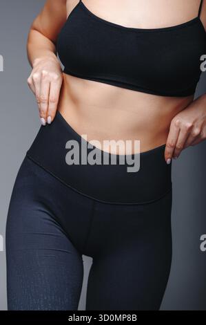 Close up view of female model posing at gray studio background Stock Photo