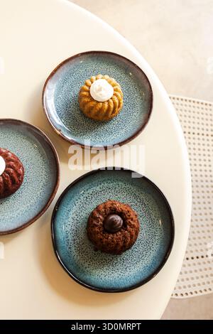 Mini bundt cakes on blue ceramic plates Stock Photo
