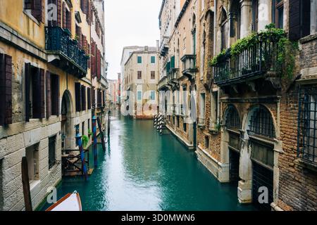 Rainy day in Venice Italy with ripples and raindrops on calm canal water creating atmospheric reflections Stock Photo
