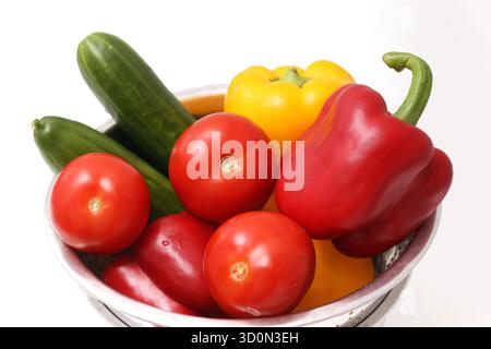 Fresh bell peppers tomatoes and cucumbers in bowl. Colorful raw vegetables composition. Healthy food ingredients on white background. Natural cooking. Stock Photo