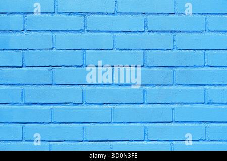 Blue painted brick wall texture background. Clean masonry surface with visible bricks. Urban architectural pattern for design use. Stock Photo