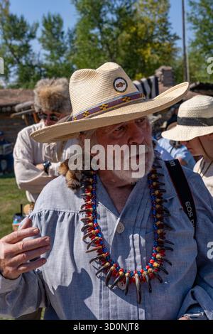 A man in period dress with a bear claw necklace at the Fort Bridger Rendezvous at the Fort Bridger Historic Site in Wyoming. Stock Photo