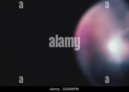Purple violet light effect on black background. Abstract wallpaper. Analog film effect. Blurred defocused. Lo-fi effect. Stock Photo