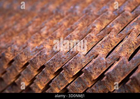 Perforated rusty metal floor sheet stamping plates texture closeup angled view. Metal stamping sheet metal manufacturing lightweight bearing flooring Stock Photo
