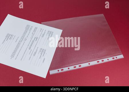 Put your document in the plastic sleeve. Saving and protection concept Stock Photo
