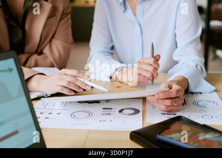 Middle Aged Woman and Young Adult Man Analyzing Financial Charts Stock Photo