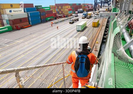 San Antonio, Valparaiso Region, Chile- Ship crew members in high visibility gear descends the gangway at the Port of San Antonio Stock Photo