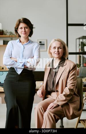 Middle Aged Women Collaborating in Modern Office Environment Stock Photo
