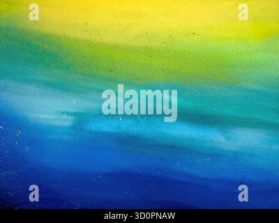 Painted wall with a color gradient from yellow to blue as a background Stock Photo