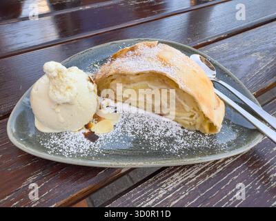 A slice of apple strudel with vanilla ice cream Stock Photo