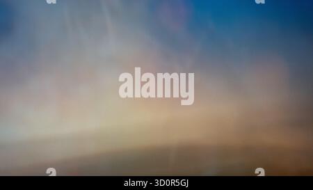 Smooth abstract background blending warm beige and cool blue tones with soft transitions. Minimal blurred gradient texture ideal for design Stock Photo