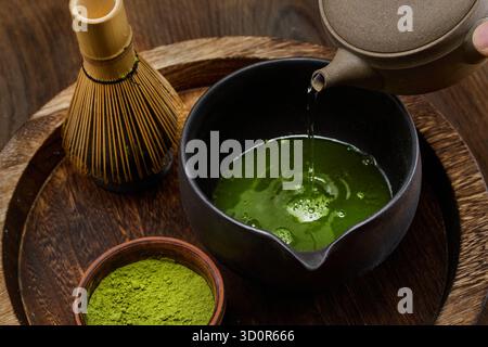 Traditional Matcha Ceremony. High-angle view of matcha tea being prepared with a bamboo whisk Stock Photo