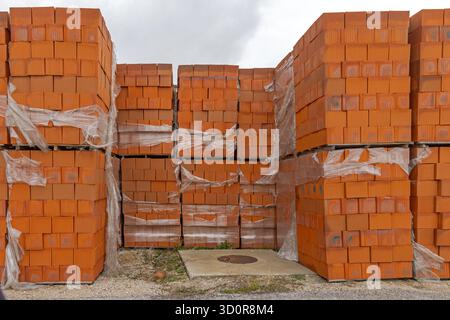Orange Building Blocks at Stacked Pallets Construction Material Storage Stock Photo