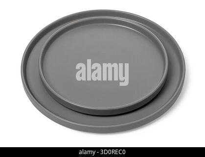 Stacked round gray ceramic dinner plates presenting minimalist kitchen styling Stock Photo