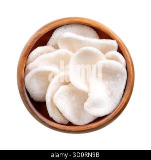 Prawn crackers, shrimp chips in a wooden bowl. Deep-fried crackers made from a dough of tapioka, ground prawns, and seasonings. Stock Photo