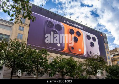 Large advertising billboard for the Apple iPhone 17 Pro smartphone covering the scaffolding of restoration work on the facade of a Parisian building Stock Photo