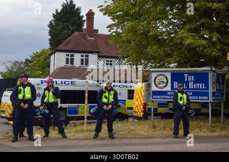 Epping, UK. 27th July 2025. A heavy police presence outisde the Bell Hotel in Epping as both pro- and anti- migrant protesters gather. Several anti-migrant protests targeting the hotel have taken place, after an asylum seeker was charged with allegedly trying to kiss a 14-year-old girl. Credit: Vuk Valcic/Alamy Stock Photo