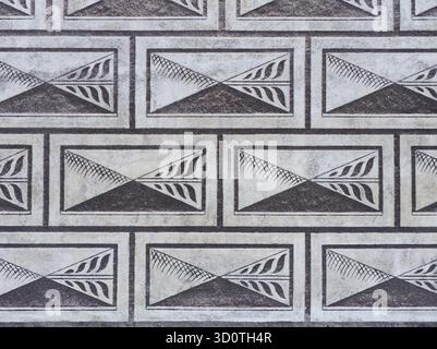 Repeating geometric pattern with triangular designs in rectangular frames on architectural surface Stock Photo