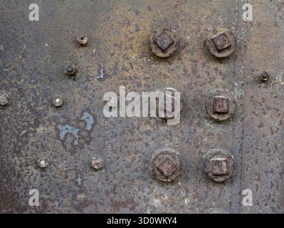 Rusty steel metal texture with rivets as steam punk. Rust metal texture with rivets background. Stock Photo