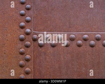 Rust steel metal texture with rivets as steam punk. Rust metal texture with rivets background. Stock Photo