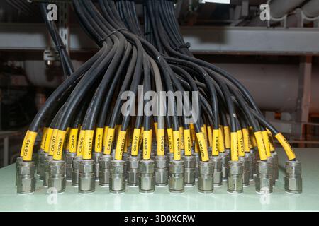 Several powerful electrical cables connected to a junction box Stock Photo