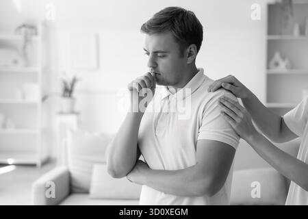 Young woman supporting sad man with suicidal thoughts at home Stock Photo