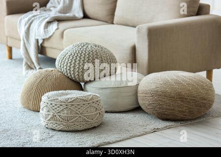 Different poufs on carpet in living room Stock Photo