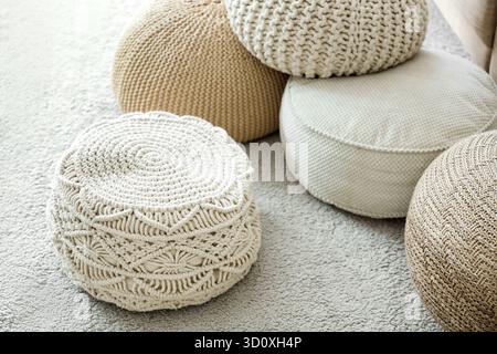 Different poufs on carpet in living room Stock Photo