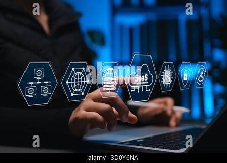 SaaS Platform Technology and Cloud-Based Solutions. User interacts with interface SaaS icons, symbolizing software as a service, cloud computing, Stock Photo