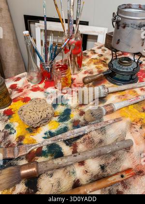 arrangement of artists brushes and other equipment on work table Stock Photo