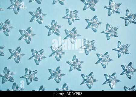 Pattern of transparent stars on a blue background. Stock Photo