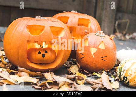 Halloween carved pumpkins with autumn leaves Stock Photo