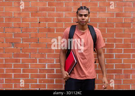 Young college student with backpack and notebook Stock Photo